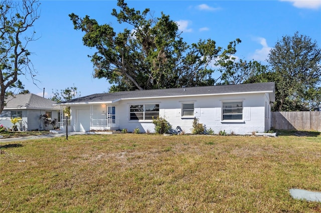 ranch-style house with a garage and a front yard