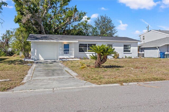 ranch-style home with a garage and a front lawn