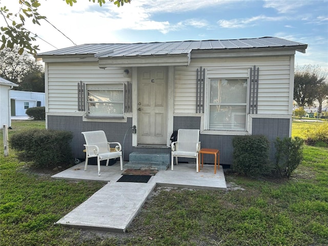 back of property with a patio and a lawn