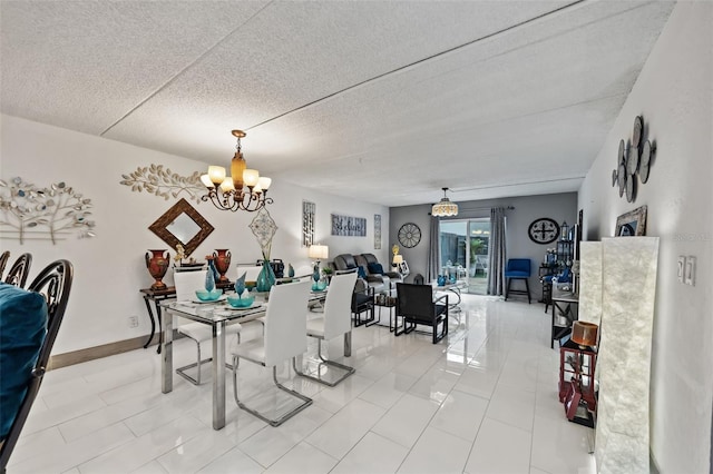 tiled dining area featuring a notable chandelier and a textured ceiling