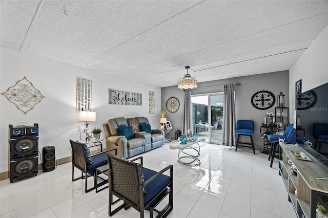 living room with an inviting chandelier and a textured ceiling