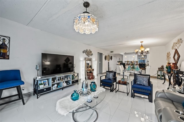 living room with tile patterned flooring, a textured ceiling, and an inviting chandelier