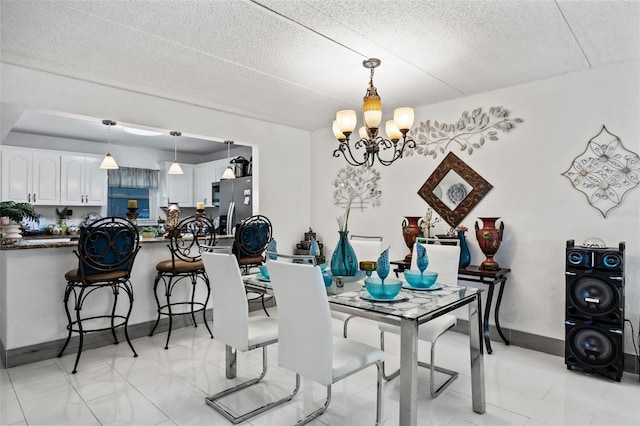 dining area with a notable chandelier and a textured ceiling