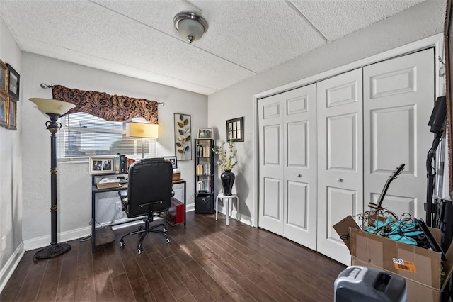 home office with dark hardwood / wood-style flooring