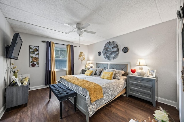 bedroom with a textured ceiling, dark hardwood / wood-style floors, and ceiling fan