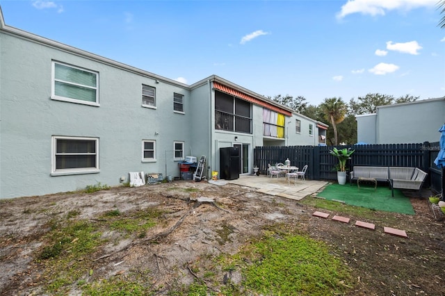 back of property featuring a patio area