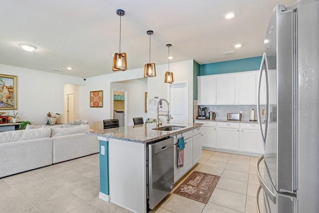 kitchen with sink, white cabinetry, decorative light fixtures, a center island with sink, and appliances with stainless steel finishes