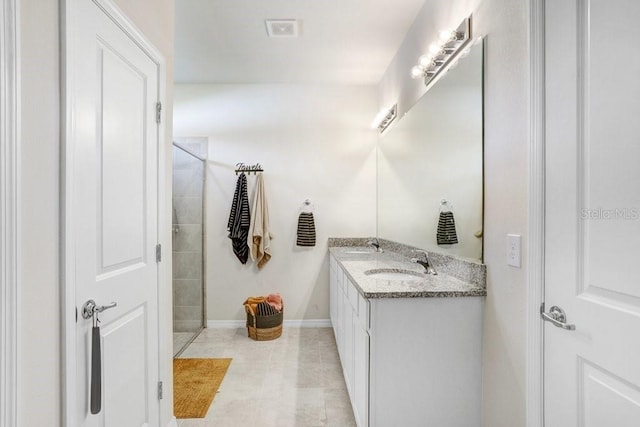 bathroom with vanity, tile patterned flooring, and walk in shower