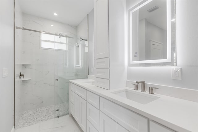 bathroom with a shower with door and vanity