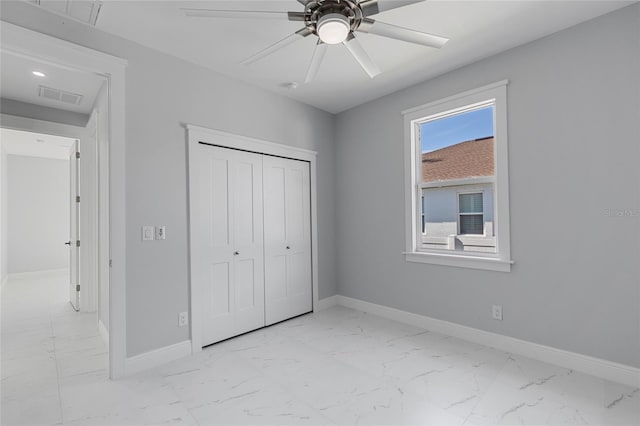 unfurnished bedroom with ceiling fan and a closet