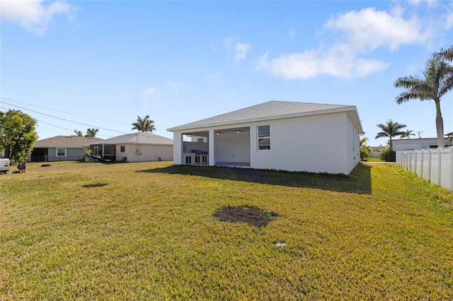 rear view of house with a yard