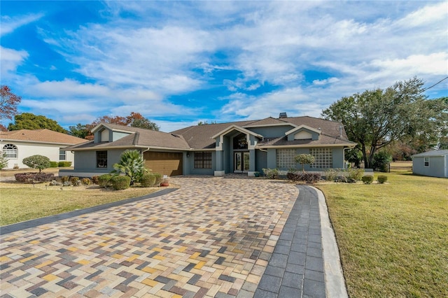 view of front facade featuring a garage and a front lawn