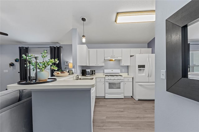 kitchen featuring a breakfast bar, white cabinetry, hanging light fixtures, kitchen peninsula, and white appliances