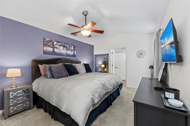 bedroom featuring ceiling fan, light colored carpet, and lofted ceiling