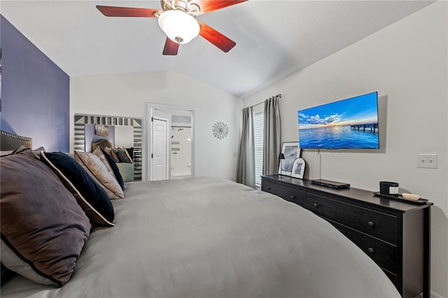 bedroom featuring vaulted ceiling, ceiling fan, and ensuite bath