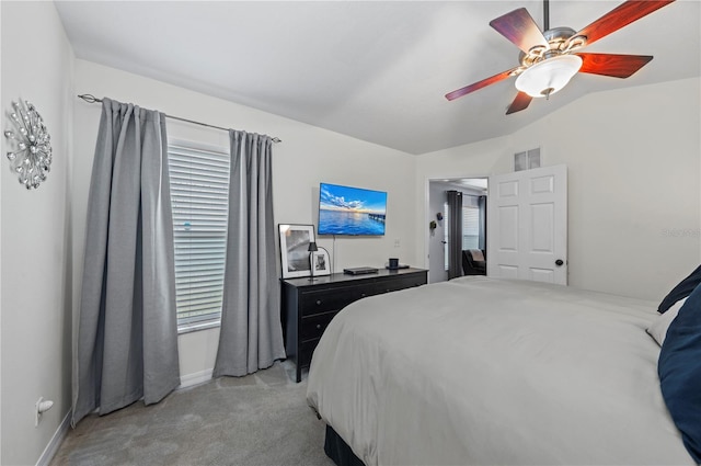 bedroom featuring lofted ceiling, light colored carpet, and ceiling fan