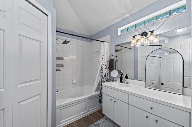 bathroom featuring shower / bath combo, vaulted ceiling, wood-type flooring, and vanity