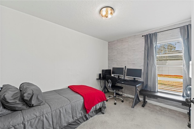 bedroom featuring a textured ceiling and carpet flooring