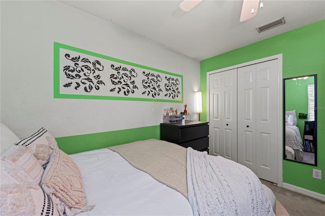 carpeted bedroom featuring ceiling fan and a closet