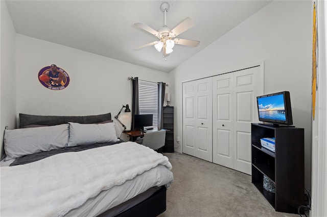 carpeted bedroom with ceiling fan, vaulted ceiling, and a closet