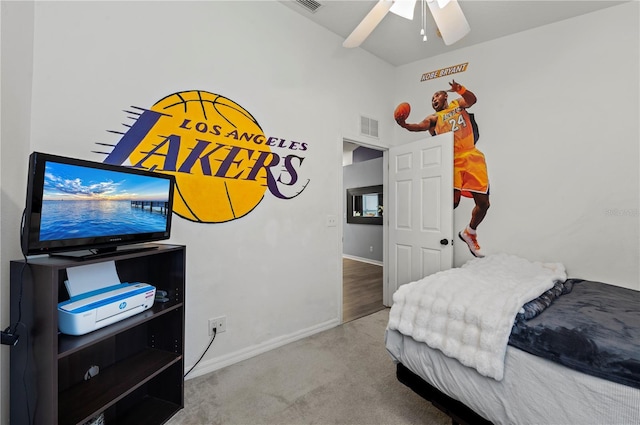 bedroom featuring ceiling fan, light colored carpet, and vaulted ceiling