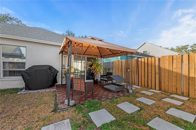 view of patio with area for grilling, a gazebo, and an outdoor hangout area