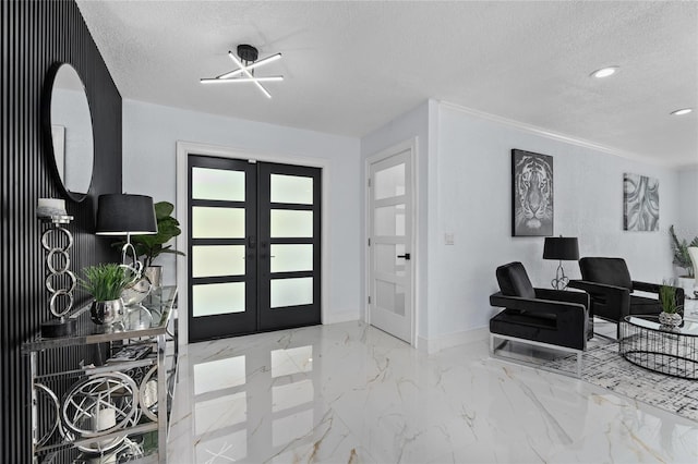 foyer featuring ornamental molding, french doors, and a textured ceiling