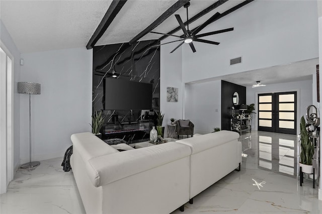 living room featuring ceiling fan, high vaulted ceiling, french doors, and a textured ceiling