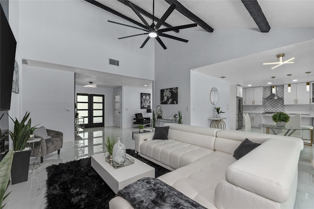 living room featuring french doors, ceiling fan, beam ceiling, and high vaulted ceiling