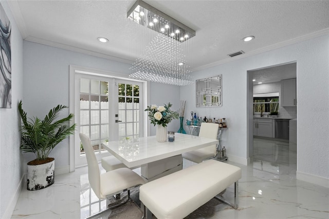 dining area featuring sink, crown molding, a textured ceiling, french doors, and a chandelier