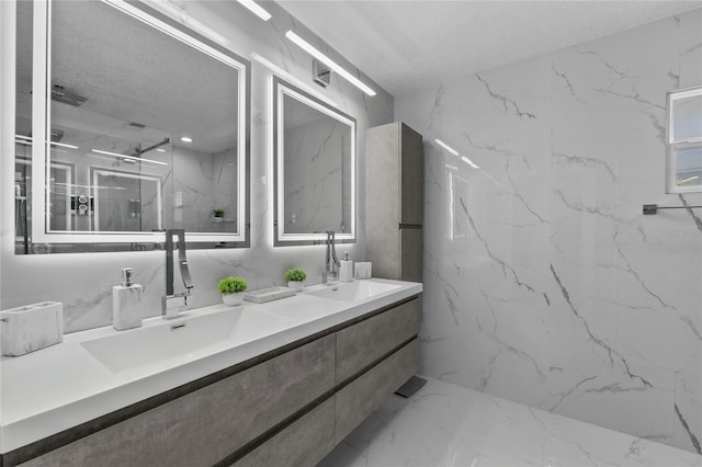 bathroom featuring vanity, a shower, and a textured ceiling