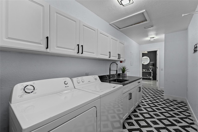 laundry area with cabinets, sink, a textured ceiling, and independent washer and dryer