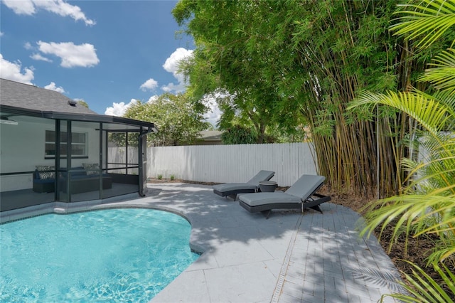 view of pool featuring a sunroom and a patio