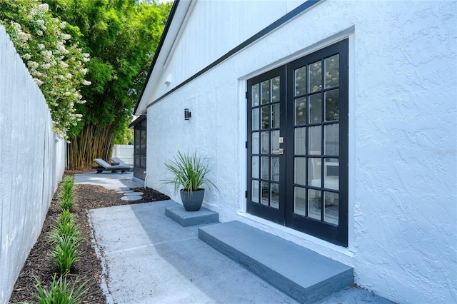 entrance to property featuring a patio area and french doors