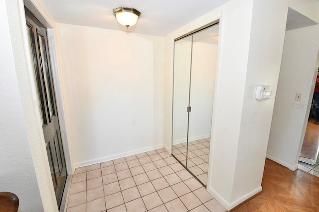 hall with light tile patterned flooring