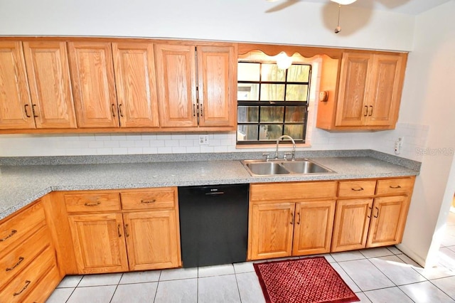 kitchen with light tile patterned flooring, black dishwasher, sink, and backsplash