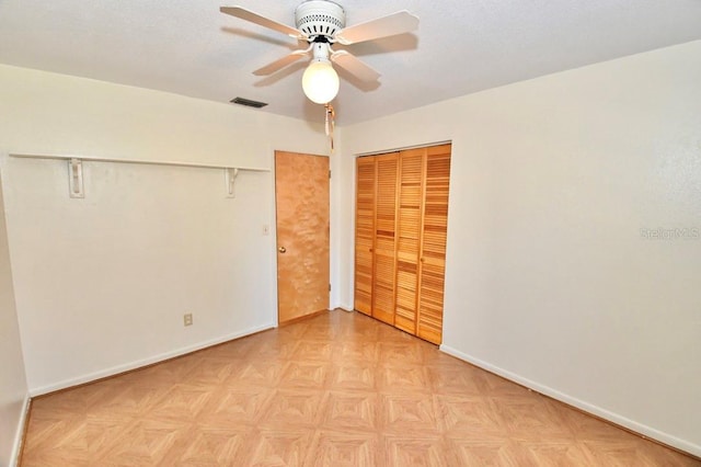 unfurnished bedroom with ceiling fan, a textured ceiling, and light parquet flooring