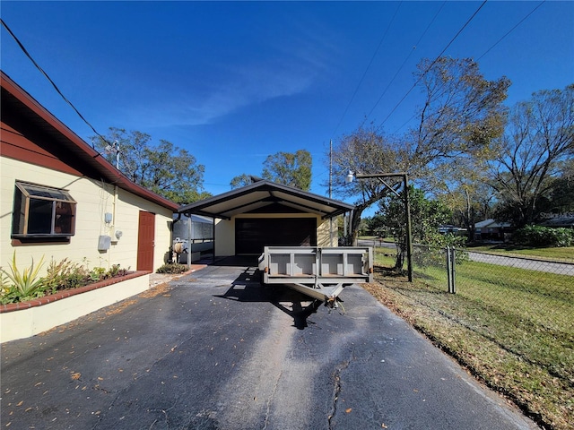 view of front of home with an outbuilding, a garage, and a carport