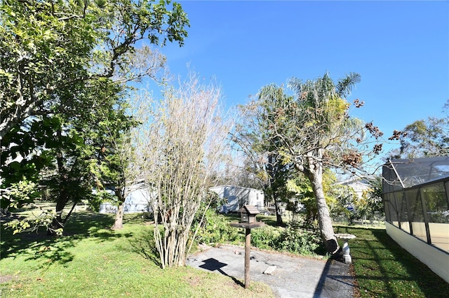 view of yard featuring glass enclosure