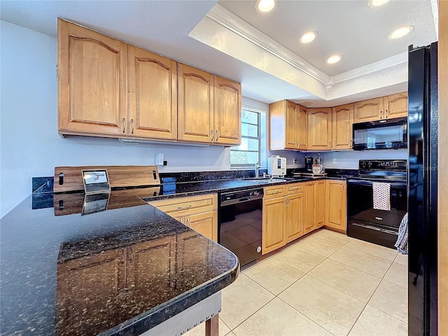 kitchen featuring sink, crown molding, light tile patterned floors, a tray ceiling, and black appliances