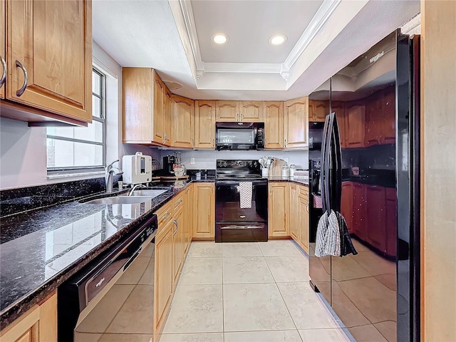 kitchen with sink, crown molding, a raised ceiling, dark stone counters, and black appliances