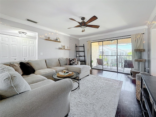 living room with crown molding, dark wood-type flooring, and ceiling fan