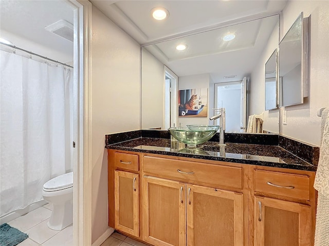 bathroom with walk in shower, tile patterned floors, toilet, and vanity