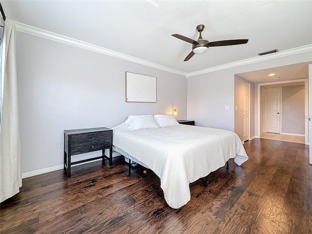 bedroom featuring dark wood-type flooring, ceiling fan, and ornamental molding