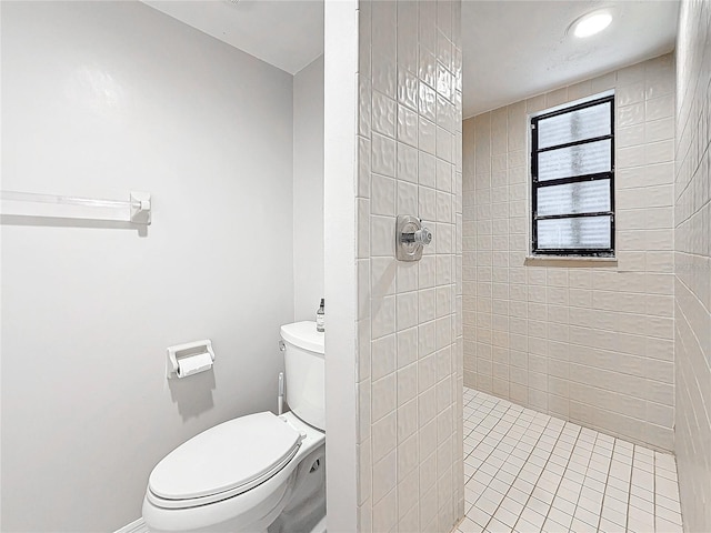 bathroom featuring tiled shower and toilet