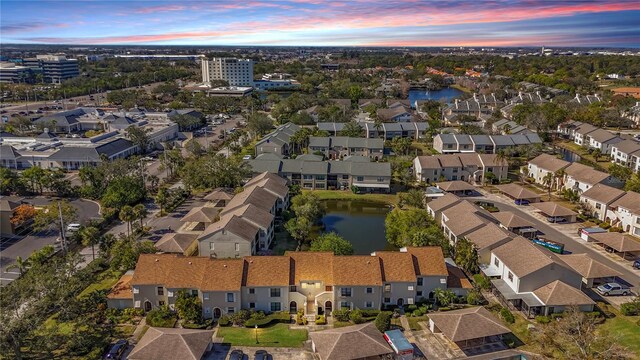 aerial view at dusk of a water view and a residential view