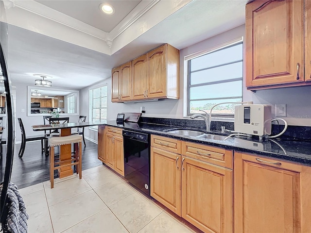 kitchen featuring black dishwasher, a sink, dark stone countertops, light tile patterned flooring, and ornamental molding