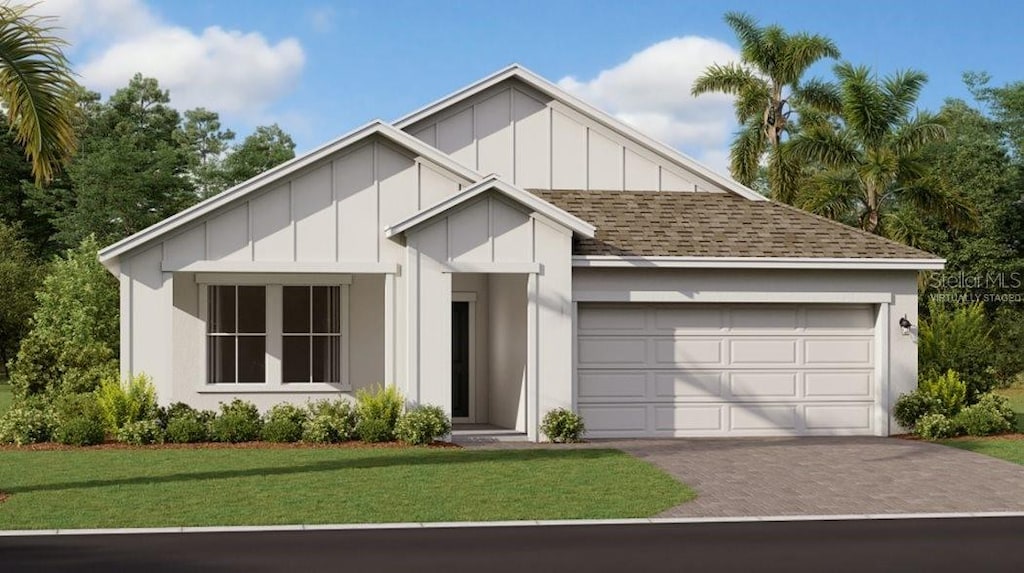 view of front of property with a garage and a front yard