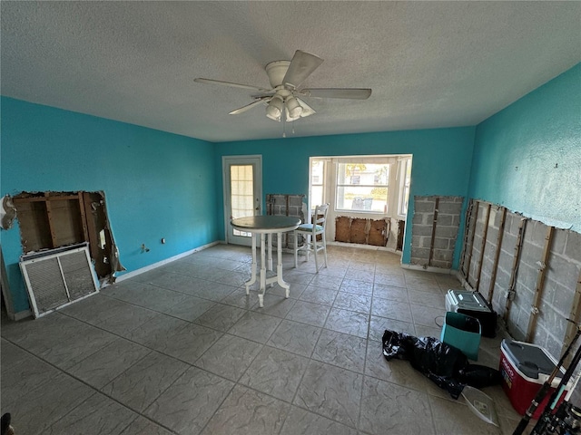 interior space featuring a textured ceiling and ceiling fan