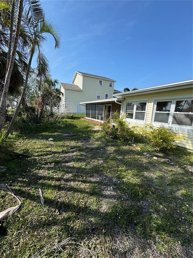 view of yard with a sunroom